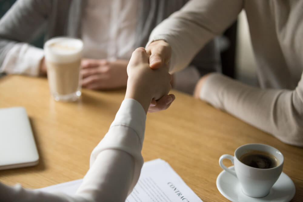 couple-handshaking-businesswoman-making-deal-in-cafe-close-up-view.jpg